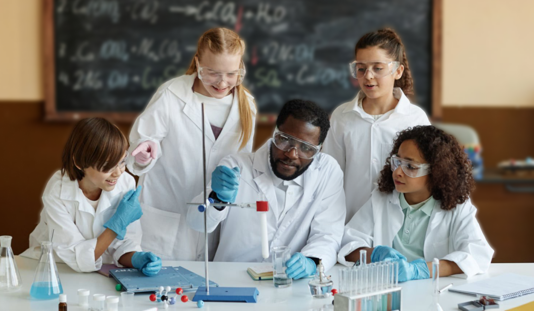 KS3 science teacher guiding students during a classroom experiment with test tubes and lab equipment.